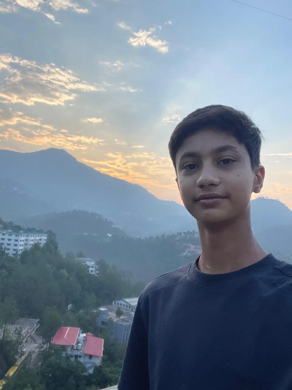 Aaradhy Badjatya at sunset, smiling slightly, framed in the Eka mark